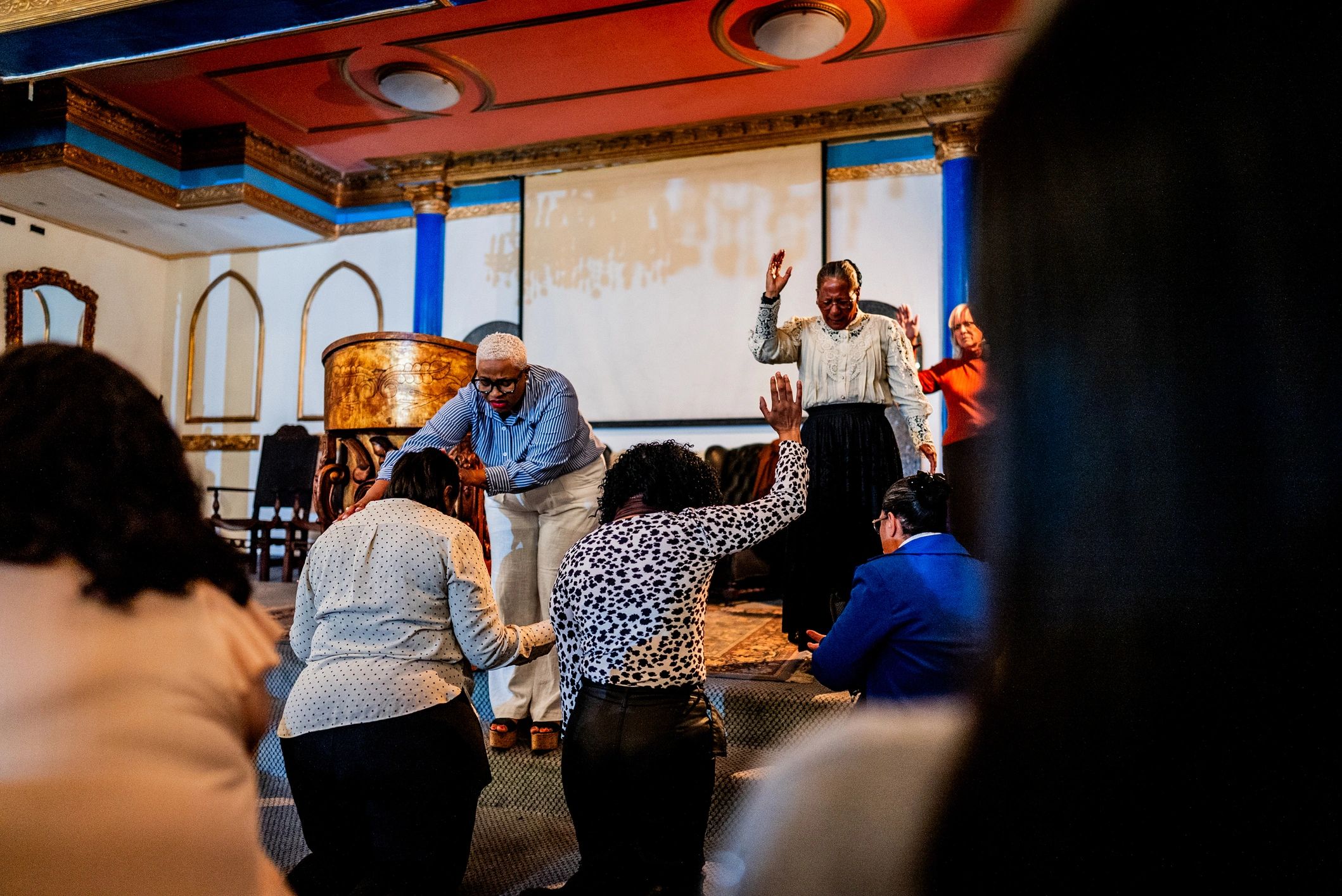 Pastor leading prayer during a worship service