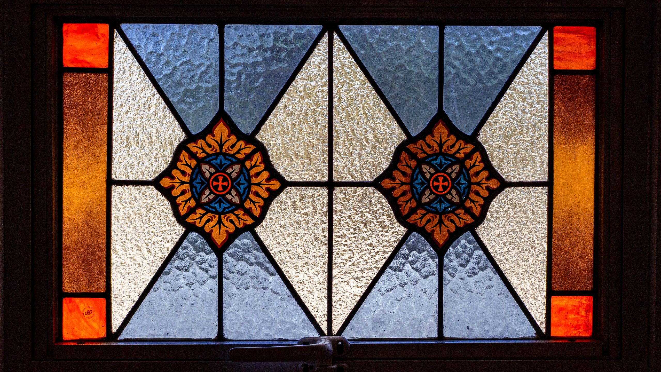 Close-up of a stained glass window with vibrant colors