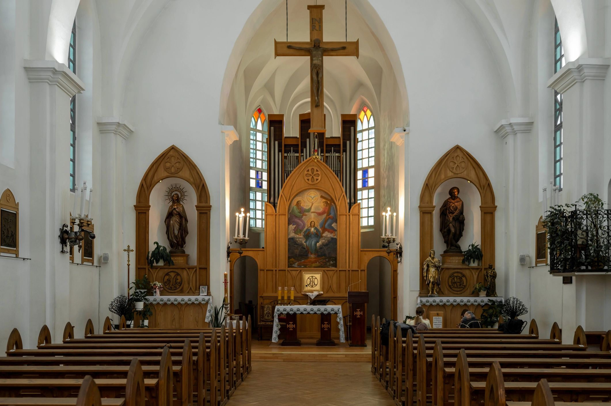 Church sanctuary interior with pews and central aisle
